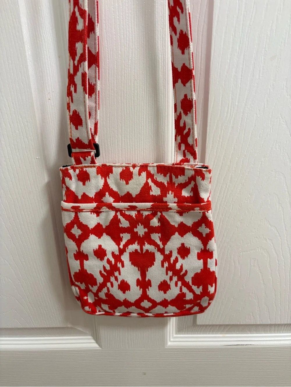 KAVU small cross body bag, orange and white pattern, snap top closure